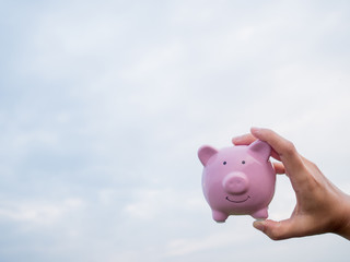 pink piggy bank on the blue sky with cloud background, Saving money for future plan and retirement fund concept
