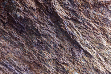 Stone background, rock wall backdrop with rough texture. Abstract, grungy and textured surface of stone material. Nature detail of rocks.