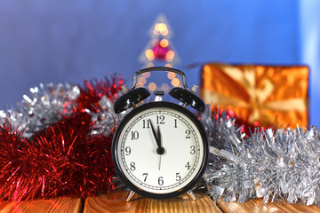 Fototapeta na wymiar Christmas alarm clock with pine branches and decorations. Christmas timer. Time to celebrate