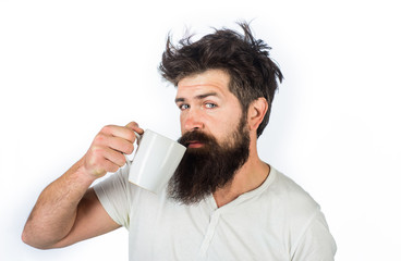 Man with cup of coffee in kitchen. Refreshment and energy. Man holds mug with hot drink. Cup of...