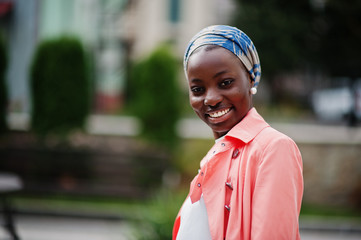 Young modern fashionable, attractive, tall and slim african muslim woman in hijab or turban head...