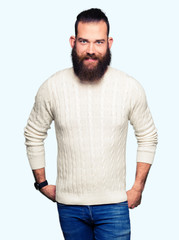 Fototapeta premium Young hipster man wearing winter sweater with a happy and cool smile on face. Lucky person.