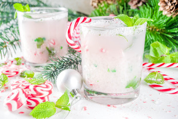 Christmas candy cane mojito cocktails with sweet. fresh mint and christmas decoration on white table