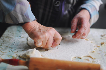 Woman molds Ukrainian dumplings.Ukrainian traditional dish