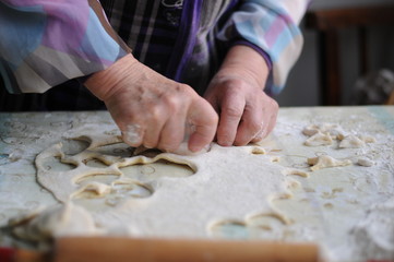 Woman molds Ukrainian dumplings.Ukrainian traditional dish