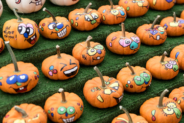 Many little funny painted pumpkins. Halloween background