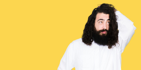 Obraz premium Man wearing Jesus Christ costume confuse and wonder about question. Uncertain with doubt, thinking with hand on head. Pensive concept.