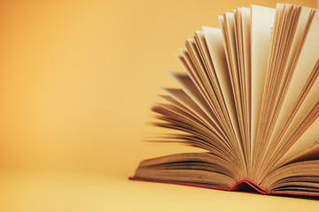 Beautiful open red book on a yellow background.