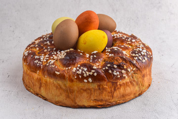 Easter brioche with cream and natural colored eggs