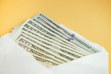 Close up Beautiful Dollars in the envelope on a yellow Background. American, US Dollars Cash Money....