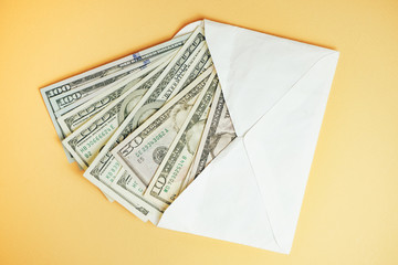 Close up Beautiful Dollars in the envelope on a yellow Background. American, US Dollars Cash Money....