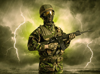Armed soldier standing in rainy obscure weather