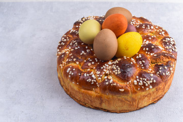 Easter brioche with cream and natural colored eggs