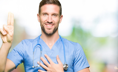Handsome doctor man wearing medical uniform over isolated background Swearing with hand on chest...