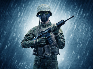 Armed soldier standing in rainy weather