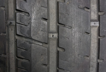 Close up of worn tire with tread wear indicator, minimum legal tread depth 