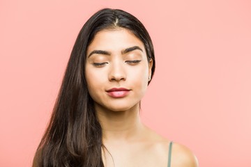 Close up of a young beauty and natural arab woman closing her eyes