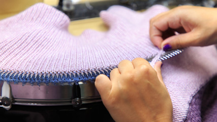 Looping machine operator working in a knitwear factory