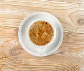 Hot coffee cup on brown wooden background top view