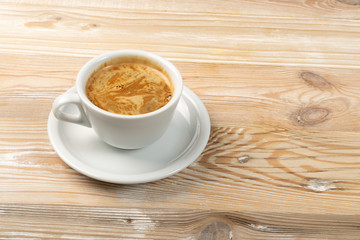 Hot coffee cup on brown wooden background top view