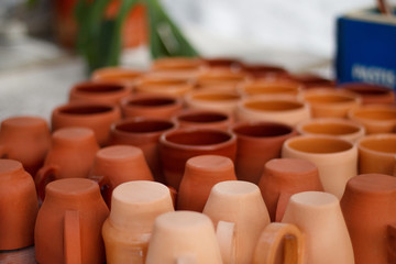 Fototapeta na wymiar ceramic dishes made of red clay cups lie on the table close-up