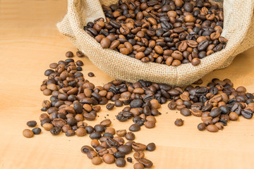 roasted coffee beans in bag on the wooden table