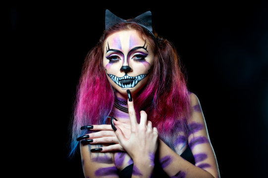 Beautiful young woman dressed as a cat. Make up cat. Halloween