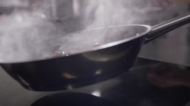 grapes being fried in a frying pan in an upscale restaurant hotel kitchen - Trauben werden in einer Pfanne in einer gehobenen K&uuml;che angebraten