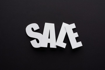 top view of white sale lettering on black background