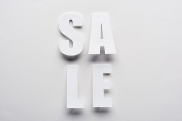 top view of white sale lettering on white background