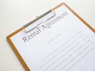 A car rental service lease contract on wooden clipboard