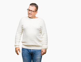 Middle age arab man wearing glasses over isolated background winking looking at the camera with...