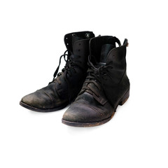 Old worn black boots isolated on a white background. Equestrian boots