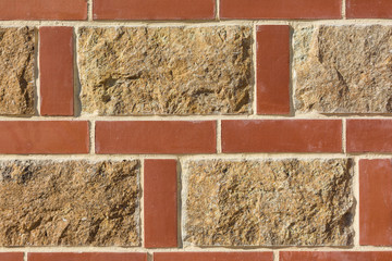 Red brick wall abstract background. Texture of bricks and stones