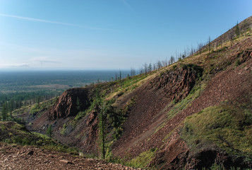 Naklejka premium Steep rocky mountains and rocks near the city of Norilsk, Russia. Dirty emissions from industrial plants turn nature into a desert.