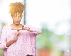 Beautiful young african american woman wearing glasses over isolated background Doing time out...