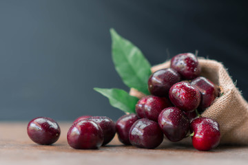 Fresh organic cherries in burlap sack