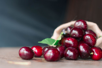 Fresh organic cherries in burlap sack