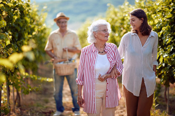 Wine and grapes. Family tradition. Harvesting grapes. mother and daughter on autumn vineyard .