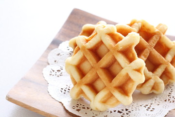 Waffle on wooden plate for gourmet dessert