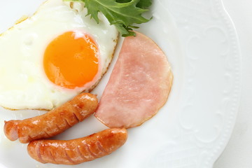 Homemade sausage and sunny side up fried egg with ham