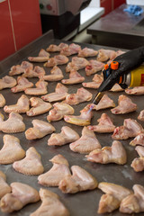  cooking chicken legs in a restaurant