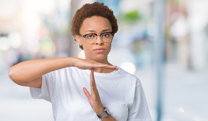 Beautiful young african american woman wearing glasses over isolated background Doing time out...