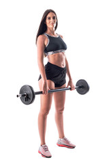 Confident athletic woman gym girl holding barbell looking at camera in black sportswear. Full body isolated on white background. 
