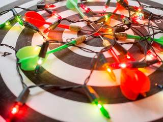 Target six dart focus on bull's eye Dart Board with party light, Funly setting challenging business goals And ready to achieve the goal concept