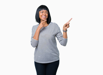 Beautiful young african american woman wearing stripes sweater over isolated background smiling and looking at the camera pointing with two hands and fingers to the side.