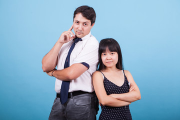Naklejka premium Cheerful young interracial couple looking at the camera in studio
