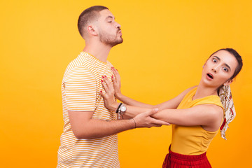 Beautiful girlfriend refusing kisses from her romantic boyfriend