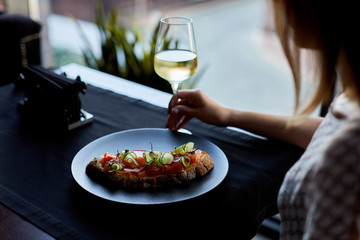 woman eating salad in restaurant
