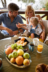 Young family with child having breakfast